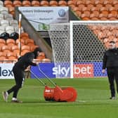 Blackpool groundstaff trying to remove the water of the playing surface. Picture: Picture Howard Roe/AHPIX