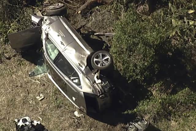 In this aerial image take from video provided by KABC-TV video, a vehicle rest on its side after a rollover accident involving golfer Tiger Woods along a road in the Rancho Palos Verdes section of Los Angeles on Tuesday, Feb. 23, 2021. (KABC-TV via AP)