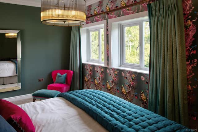 The main bedroom with Kit Miles wallpaper and curtains  by Clarke and Clarke edged with a pink border