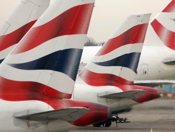 Library image of tail fins of British Airways' aircraft parked at Terminal One of Heathrow Airport