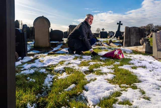 Joe's great-grandson Matthew Delaney at his unmarked grave in Doncaster. (James Hardisty).