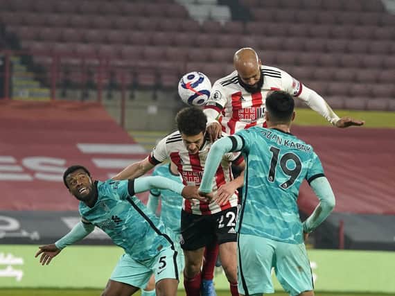 Sheffield United forward David McGoldrick rises high against the Liverpool defence. PICTURE: SPORTIMAGE.