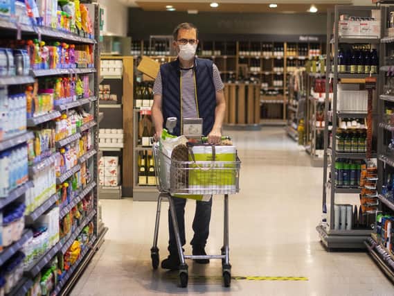 File photo of a shopper wearing a face mask in a supermarket.