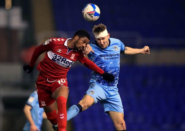Middlesbrough's Chuba Akpom (left) and Coventry City's Kyle McFadzean battle for the ball. Picture: PA.
