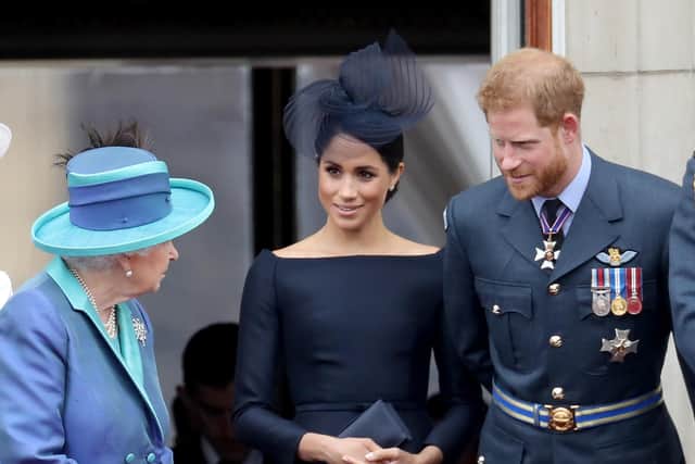 The Queen with the Duke and Duchess of Sussex on the Buckingham Palace balcony to mark the centanry of the RAF in 2018.