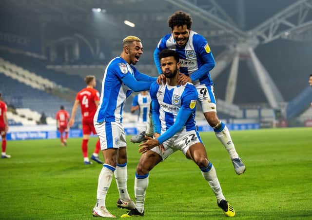 Fraizer Campbell celebrates scoring Huddersfield's opening goal with Juninho Bacuna and Duane Holmes.  Picture Bruce Rollinson
