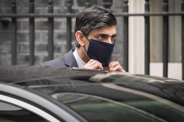Chancellor Rishi Sunak leaves Downing Street to deliver his Budget.