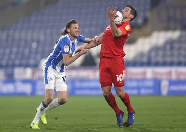 BACK IN THE GAME: Huddersfield Town's Richard Stearman battles with Birmingham City's Lukas Jutkiewicz at John Smith's Stadium on Tuesday night. Picture: George Wood/Getty Images.