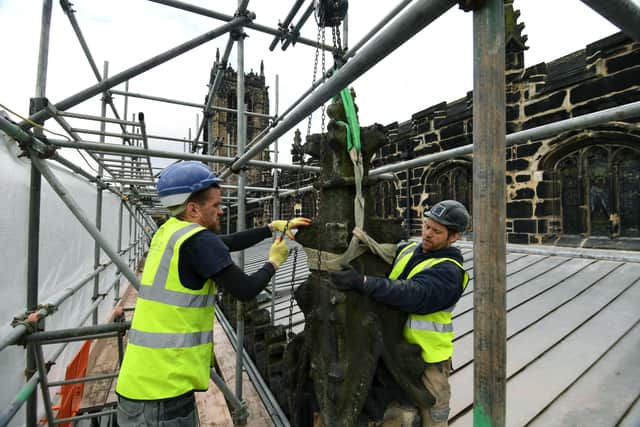 Anthony Taylor and Chris Clarke from Heritage Conservation  lifting of one of the pinnacles before repair.
 Picture: Jonathan Gawthorpe