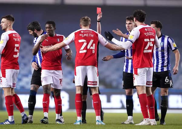 Rotherham United's Michael Smith (centre) reacts as he is shown a red card.