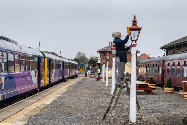 Volunteer Christine Butterworth cleaning one of the many lights at Leeming Bar station  Picture: James Hardisty