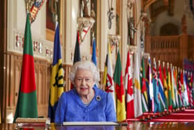 Queen Elizabeth II signs her annual Commonwealth Day Message in St George's Hall at Windsor Castle.