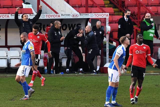 Barnsley's match winner Daryl Dike (bottom right) and the Barnsley bench celebrate at full time, after making it seven wins out of seven. Picture : Jonathan Gawthorpe