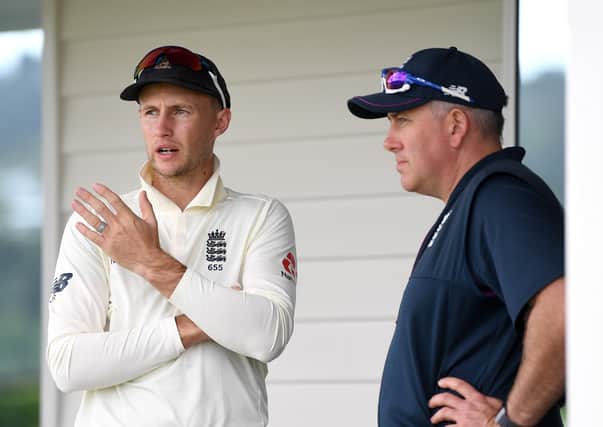 IN AND OUT: England captain Joe Root speaks with coach Chris Silverwood. Picture: Gareth Copley/Getty Images.