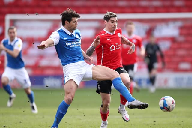 Dominik Frieser is beaten to the ball by Blues defender George Friend.