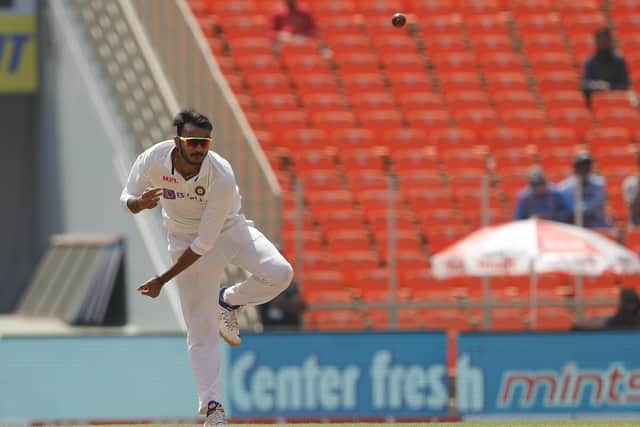 In a spin: Axar Patel on his way to a five-wicket return.