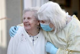 Mary Cook (left), 90, receives her first visit in three months from her daughter, Fiona Scott, at Queen's House in Kelso, in the Scottish Borders, as visiting resumes in care homes.