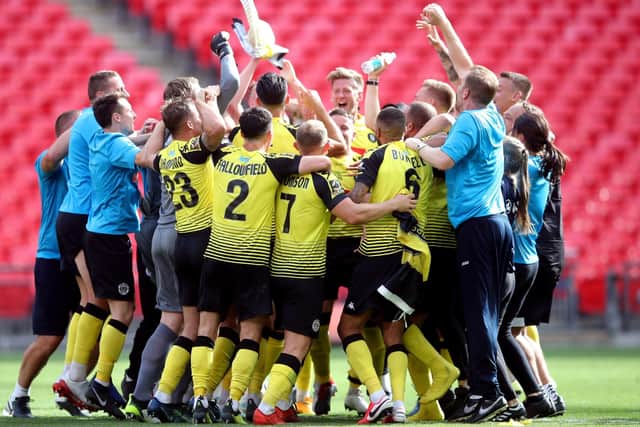 Harrogate Town players and staff celebrate after the final whistle of the National League play-off final at Wembley Stadium, (Picture: PA)