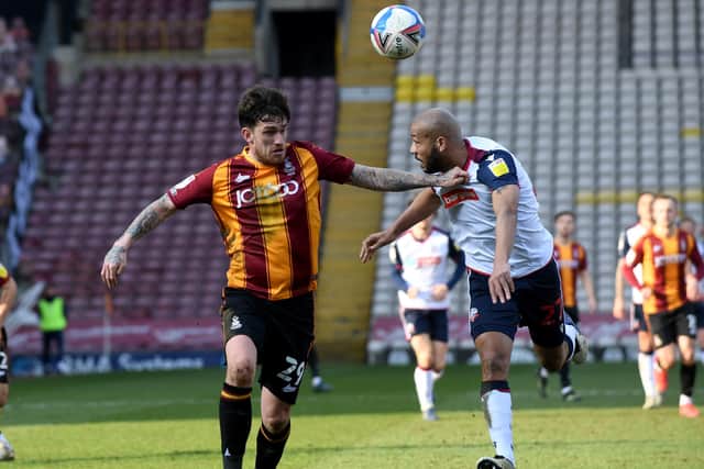Bradford player Andy Cook battles for the ball with Bolton player Lloyd Isgrove. (Picture: Simon Hulme)