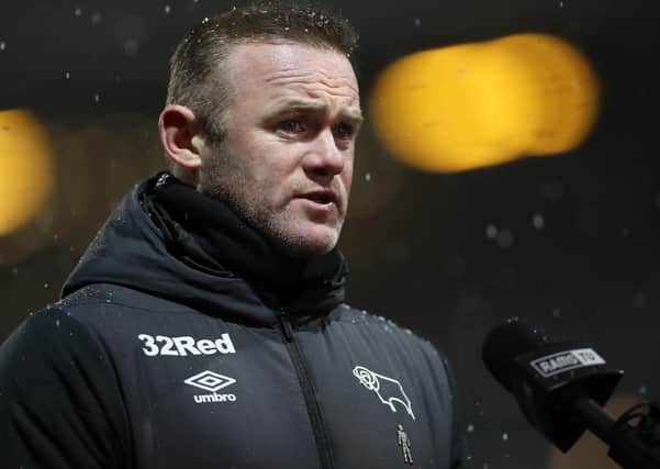 Derby county manager wayne Rooney wearing clothing branded by a betting company.