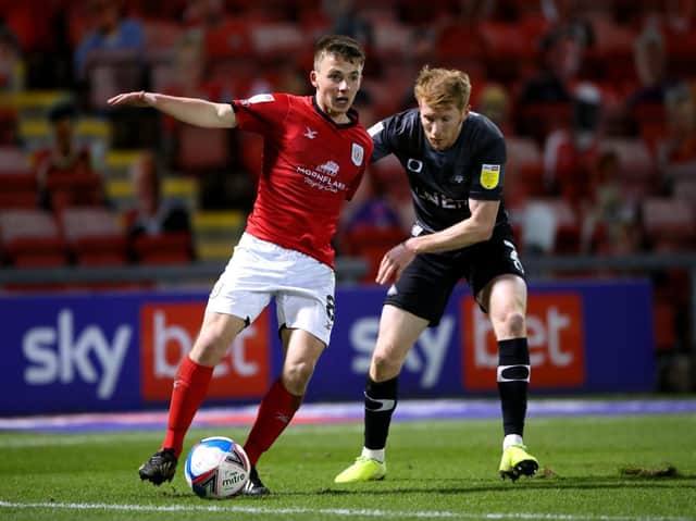 Crewe's Tom Lowery shields the ball in front of Doncaster Rovers' Brad Halliday. Picture: PA.