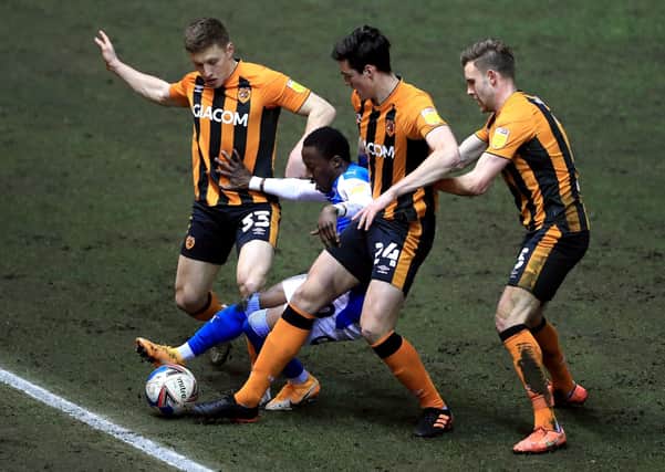 Peterborough United's Siriki Dembelel battles for the ball with Hull City's Greg Docherty (left), Jacob Greaves and Callum Elder (right). Picture: PA.