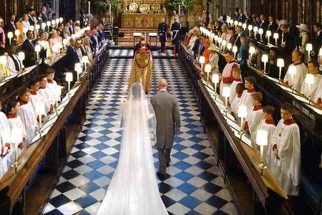 This was the Prince of Wales leading Meghan Markle down the aisle of St George's Chapel on her wedding day in May 2018. How times have changed.