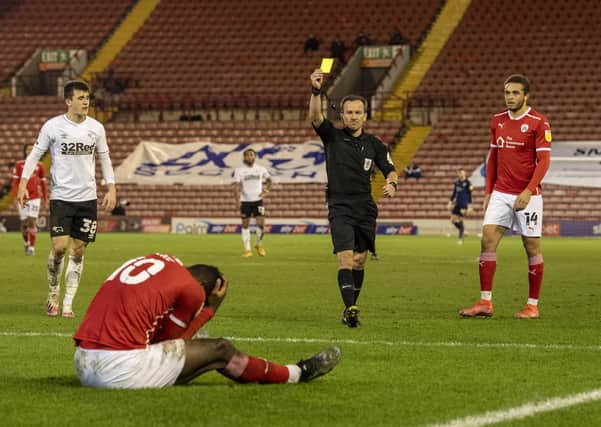 Barnsley's Daryl Dike gets a yellow card for simulation from referee Keith Stroud.   Picture: Tony Johnson