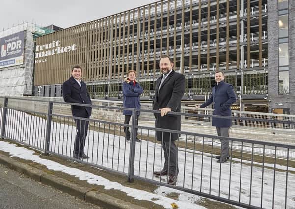 Adam Thompson of PDR Construction (left), Coun Daren Hale, Richard Beal of Beal Homes and Dominic Gibbons of Wykeland Group in front of the multi-storey car park that has opened in Hull’s Fruit Market, marking the latest milestone in the area’s regeneration.