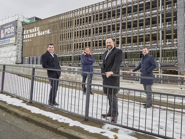 Adam Thompson of PDR Construction (left), Coun Daren Hale, Richard Beal of Beal Homes and Dominic Gibbons of Wykeland Group in front of the multi-storey car park that has opened in Hull’s Fruit Market, marking the latest milestone in the area’s regeneration.
