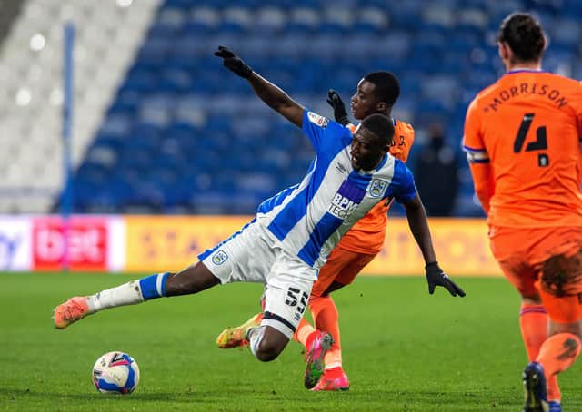 Huddersfield's Yaya Sanogo and Cardiff's Sheyo Ojo challenge for the ball.  Picture Bruce Rollinson