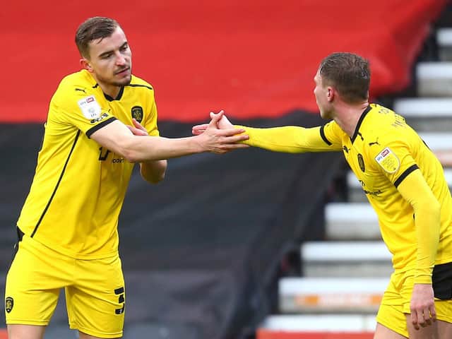 Michal Helik, left, is congratulated by Barnsley team-mate Cauley Woodrow after opening the scoring during Saturday's win at Bournemouth. Pictures: Getty Images