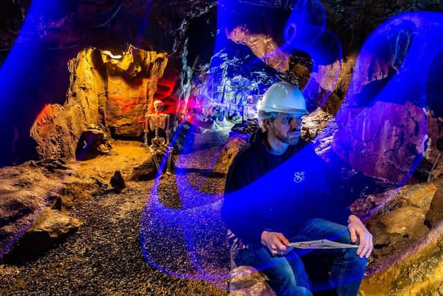Storyteller David Ault will deliver spooky ghost stories and more from Stump Cross Caverns on Friday night in a sponsored 12-hour narrathon to boost funds further. Here, Nick Markham, researches colorful trails appearing in caves ahead of the event. Image: James Hardisty