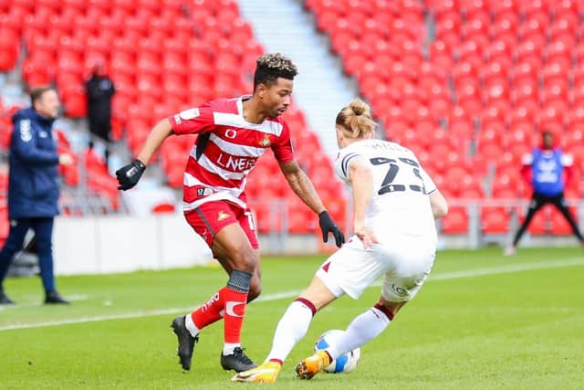Doncaster Rovers' Jason Lokilo (left) and Northampton Town's Joseph Mills battle for the ball at Keepmoat Stadium. PA Photo. Picture: Isaac Parkin/PA
