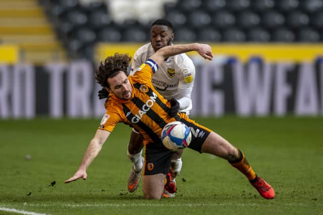 13 March 2021.....   Hull City captain Lewie Coyle is pushed to the ground  by Oxford's Olamide Shjodipo.  Picture: Tony Johnson