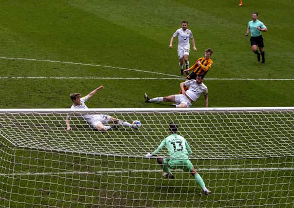 MARCHING ON: Hull City's Keane Lewis-Potter scores, his shot deflecting off Oxford's Robert Atkinson. Picture: Tony Johnson
