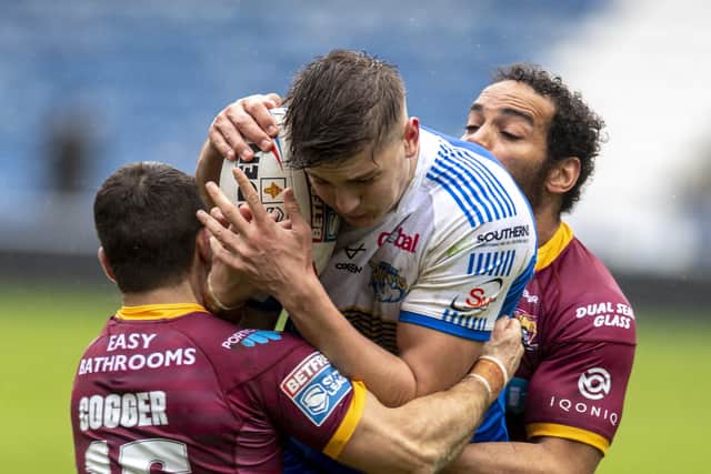 Wrapped up: Rhinos' Sam Walters is tackled by Giants' Leroy Cudjoe and Jack Cogger. Picture Tony Johnson