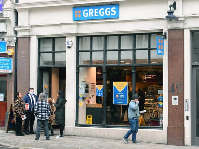 People standing around outside a Greggs in London during England's third national lockdown to curb the spread of coronaviru
