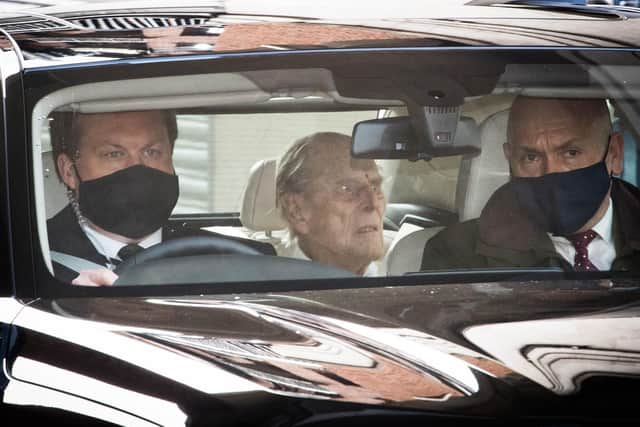 The Duke of Edinburgh (centre) is driven away in a car after leaving the King Edward VII's Hospital, London, where he has been recovering after heart surgery.