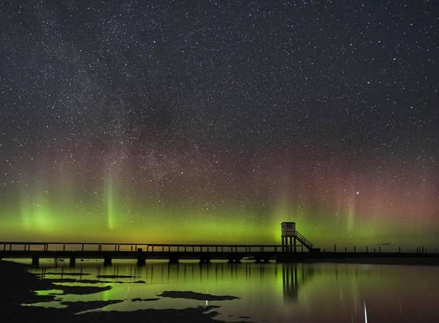 The Northern Lights above the Holy Island causeway and refuge hut