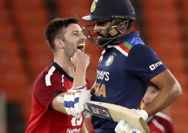 England's Mark Wood, left, celebrates the wicket of India's KL Rahul, right, during the third Twenty20 cricket match between India and England at Narendra Modi Stadium in Ahmedabad, India, on Tuesday. Picture: AP Photo/Aijaz Rahi.