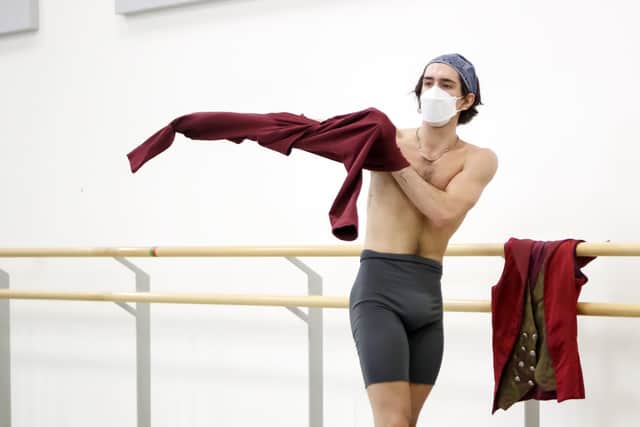 Northern Ballet dancer Lorenzo Trossello wears a face covering during a rehearsal at the Northern Ballet in Leeds.