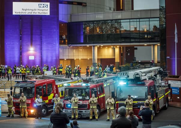 Members of the fire brigade, construction workers and members of the public, clapping outside the Nightingale Hospital at the Harrogate Convention Centre in Harrogate, to salute local heroes during a Clap for Carers NHS  celebration.