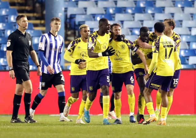 Huddersfield Town players celebrate Callum Paterson's own goal. Picture: PA.