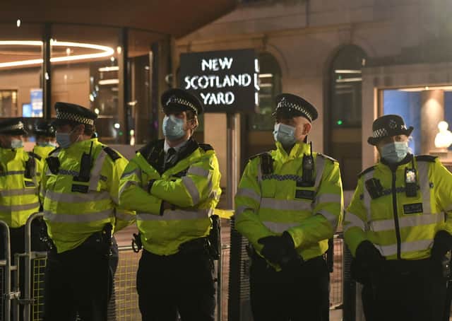 Police officers outside New Scotland Yard, central London, during a Reclaim the Streets protest in memory of Sarah Everard who went missing while walking home from a friend's flat on March 3.