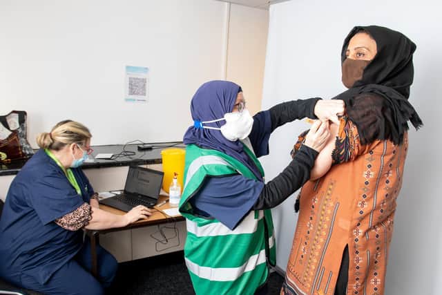 Pictured, Naz Kazmi, 50, the chief executive for Keighley Association for Women and Children's Centre (KAWACC) recieves her COVID19 vaccination from Dr Hazel Hawker. Photo credit: Bruce Rollinson/ JPIMediaResell