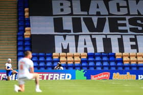 A Black Lives Matter banner as players take a knee in support of the movement during a Betfred Super League match last season.