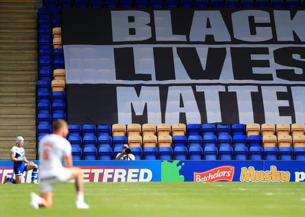 A Black Lives Matter banner as players take a knee in support of the movement during a Betfred Super League match last season.