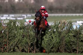 Tiger Roll and jockey Keith Donoghue clear a fence on the way to winning the Glenfarclas Chase (A Cross Country Chase) during day two of the Cheltenham Festival.