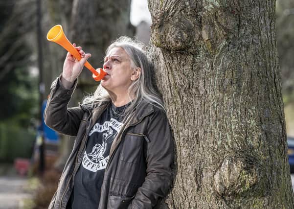 Sheffield trees campaigner Andrea Stone by the tree in the road which was saved. 
In March 2018 she went viral for being arrested for blowing a toy trumpet at a Sheffield trees protest. 
 Picture Tony Johnson
